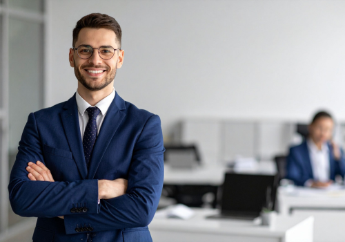man in office smiling with arms crossed