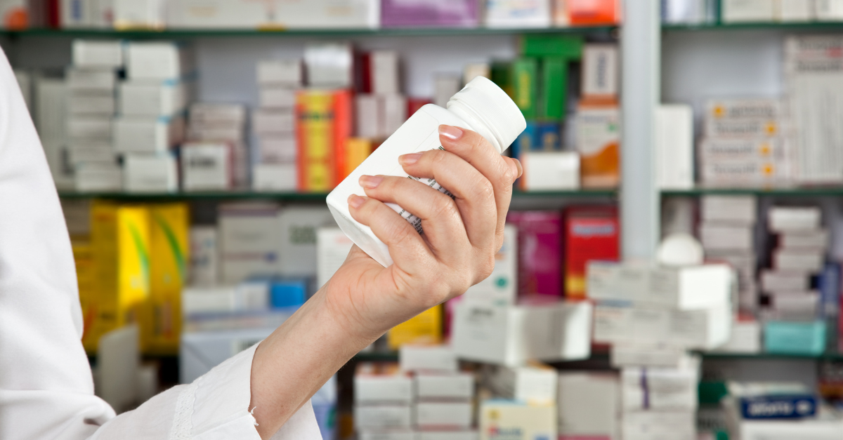 person reading product label on pharmaceutical product packaging