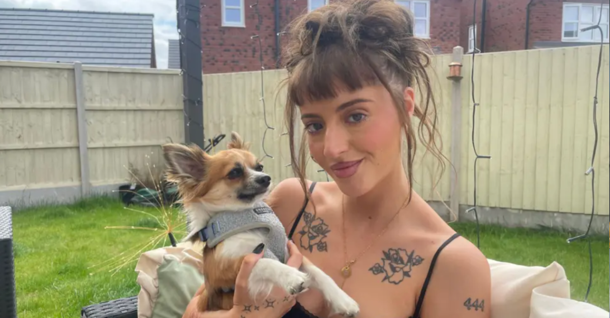 woman holding a dog in a garden