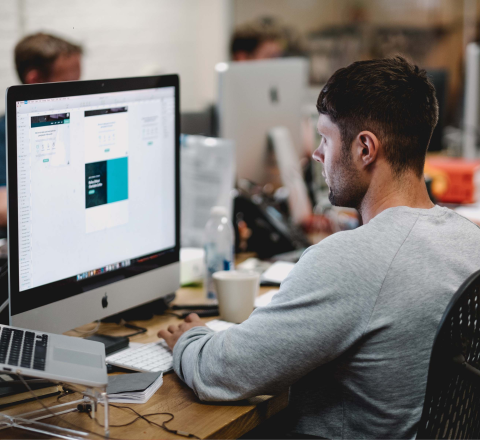 man working on artwork at computer