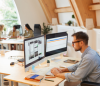 man in office designing labels on computer